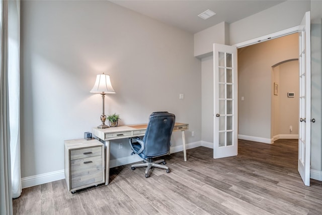 9712 Surveyor Rd, Little Elm, TX 75068 - office featuring arched walkways, french doors, wood finished floors, and baseboards
