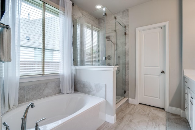 9712 Surveyor Rd, Little Elm, TX 75068 - bathroom with a bath, vanity, a shower stall, and baseboards
