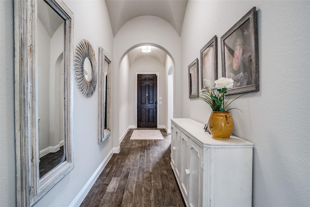 9712 Surveyor Rd, Little Elm, TX 75068 - foyer entrance featuring arched walkways, dark wood-type flooring, baseboards, and lofted ceiling
