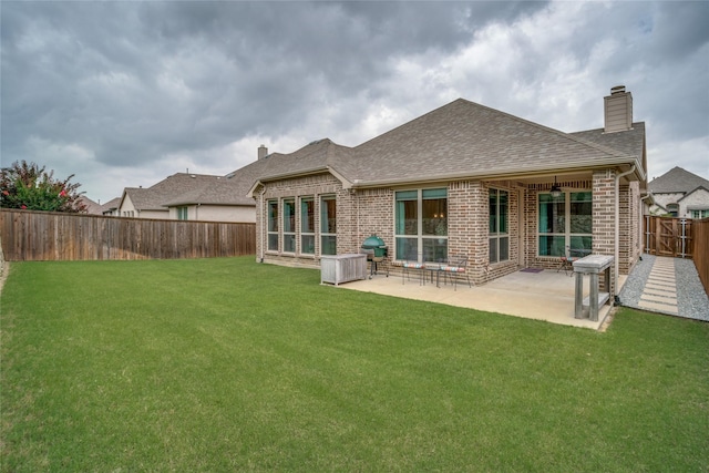 9712 Surveyor Rd, Little Elm, TX 75068 - rear view of property with brick siding, a chimney, roof with shingles, and a patio