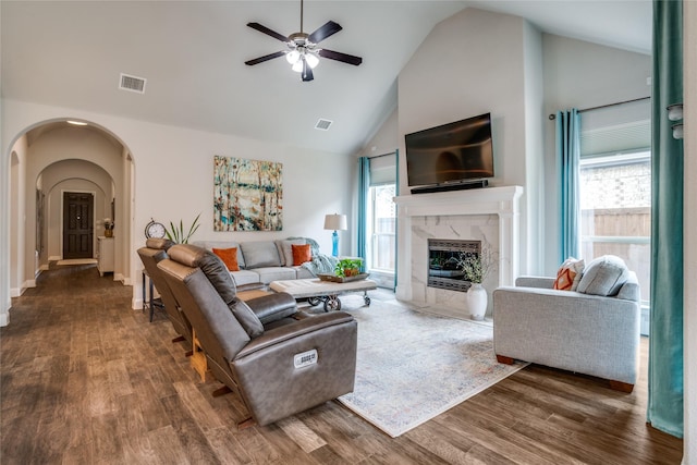 9712 Surveyor Rd, Little Elm, TX 75068 - living room with arched walkways, high vaulted ceiling, wood finished floors, a ceiling fan, and a fireplace
