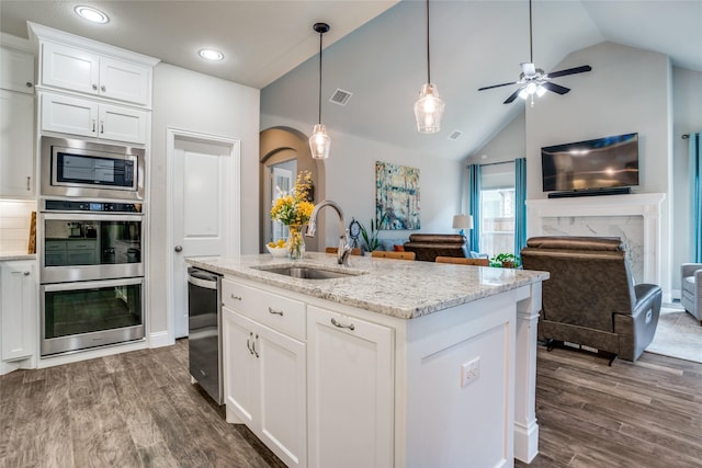 9712 Surveyor Rd, Little Elm, TX 75068 - kitchen with a sink, stainless steel appliances, vaulted ceiling, dark wood finished floors, and white cabinetry