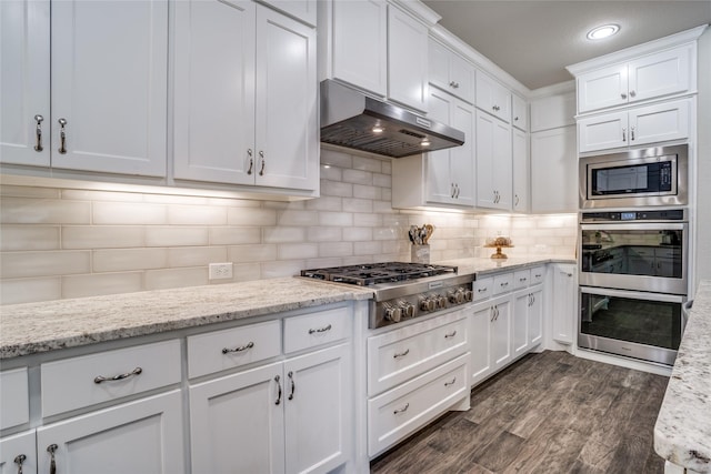 9712 Surveyor Rd, Little Elm, TX 75068 - kitchen with under cabinet range hood, appliances with stainless steel finishes, white cabinetry, and recessed lighting