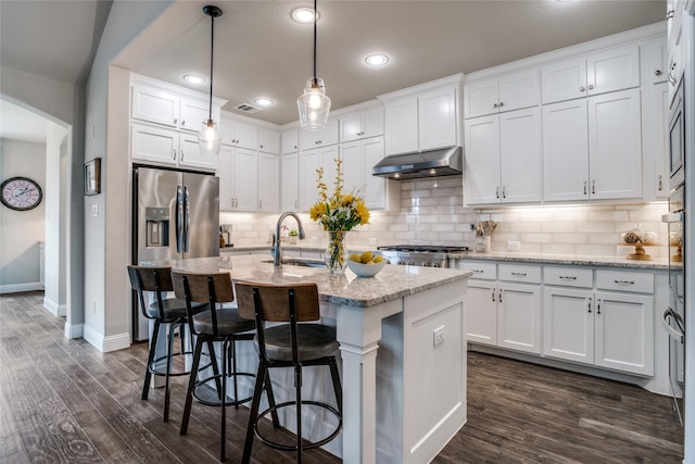 9712 Surveyor Rd, Little Elm, TX 75068 - kitchen with under cabinet range hood, baseboards, a sink, white cabinetry, and recessed lighting