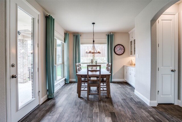 9712 Surveyor Rd, Little Elm, TX 75068 - dining space with arched walkways, dark wood-style flooring, a chandelier, and baseboards