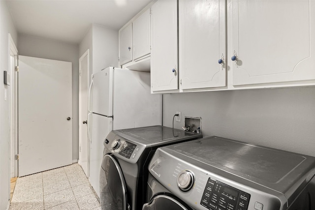 7251 Valley Dale Ct, Benbrook, TX 76116 - washroom featuring washing machine and dryer, cabinet space, and light tile patterned floors