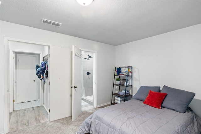 7251 Valley Dale Ct, Benbrook, TX 76116 - bedroom featuring a textured ceiling, light colored carpet, and connected bathroom