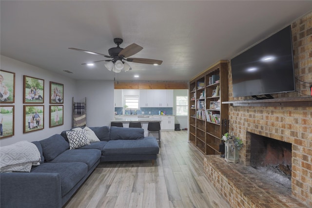 7251 Valley Dale Ct, Benbrook, TX 76116 - living area featuring light wood-type flooring, ceiling fan, a fireplace, and recessed lighting