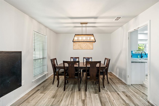 7251 Valley Dale Ct, Benbrook, TX 76116 - dining area with light wood-style flooring and a chandelier