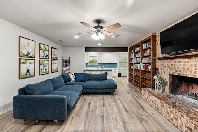 7251 Valley Dale Ct, Benbrook, TX 76116 - living area with light wood finished floors, ceiling fan, a fireplace, and recessed lighting