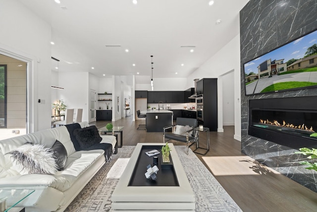 4233 Skillman St, Dallas, TX 75206 - living room featuring dark wood-style floors, recessed lighting, and a high end fireplace