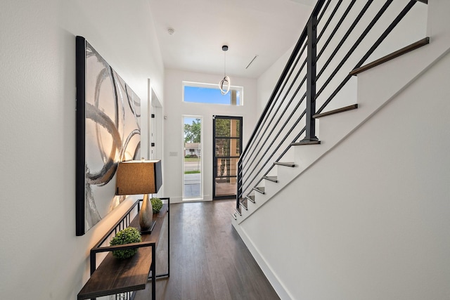 4233 Skillman St, Dallas, TX 75206 - entrance foyer featuring dark wood finished floors, stairway, and baseboards