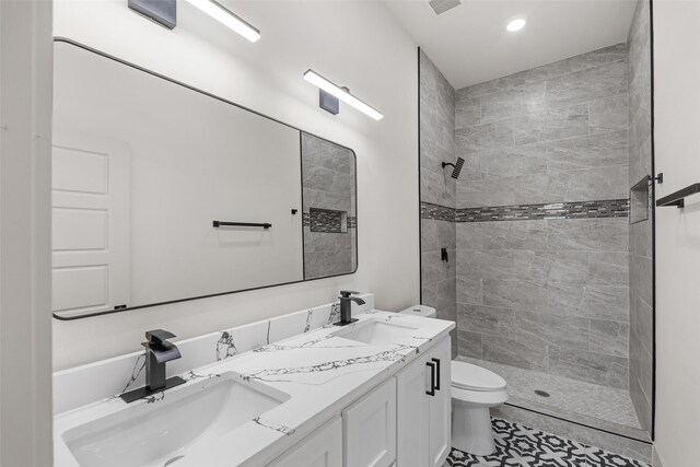 5845 Black Pine Cir, Granbury, TX 76048 - full bath featuring toilet, double vanity, tiled shower, and recessed lighting