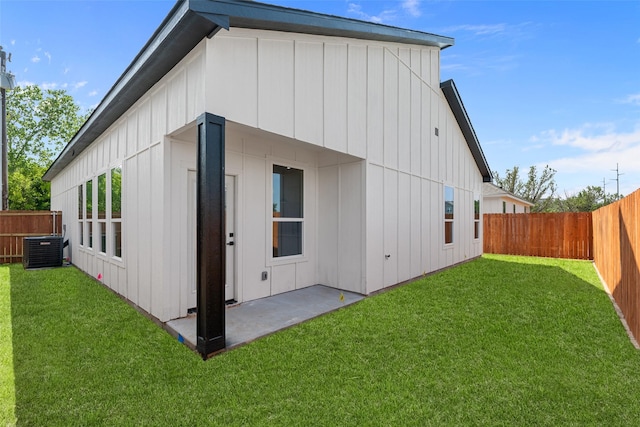 5845 Black Pine Cir, Granbury, TX 76048 - back of property with board and batten siding, central AC unit, and a patio