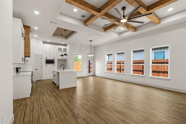 5845 Black Pine Cir, Granbury, TX 76048 - unfurnished living room with a sink, coffered ceiling, ceiling fan, baseboards, and recessed lighting