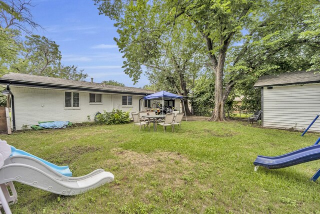 2605 Himes St, Irving, TX 75060 - view of grassy yard with a playground and outdoor dining area