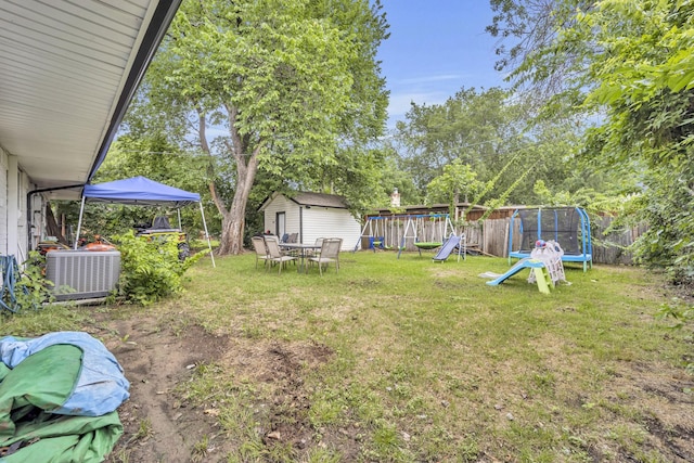2605 Himes St, Irving, TX 75060 - view of yard with a trampoline, a playground, central AC unit, and view of scattered trees