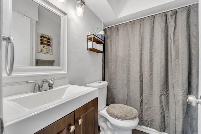 2605 Himes St, Irving, TX 75060 - full bath featuring toilet, vanity, a textured wall, and curtained shower