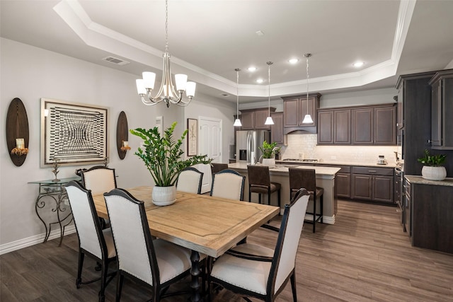 7700 Cerrito Trl, Fort Worth, TX 76123 - dining room featuring a tray ceiling, dark wood-type flooring, a chandelier, baseboards, and crown molding