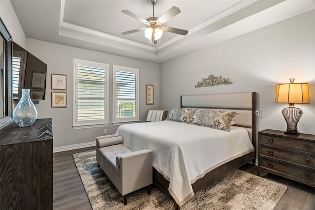 7700 Cerrito Trl, Fort Worth, TX 76123 - bedroom with a raised ceiling, wood finished floors, ornamental molding, baseboards, and ceiling fan
