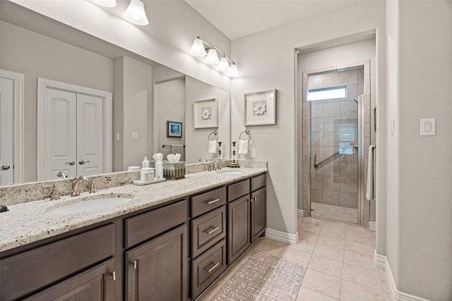 7700 Cerrito Trl, Fort Worth, TX 76123 - bathroom with double vanity, a stall shower, baseboards, and tile patterned flooring