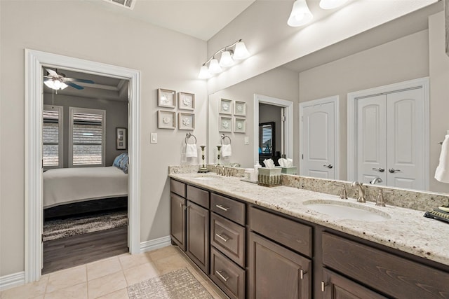 7700 Cerrito Trl, Fort Worth, TX 76123 - ensuite bathroom with double vanity, tile patterned floors, baseboards, and ceiling fan