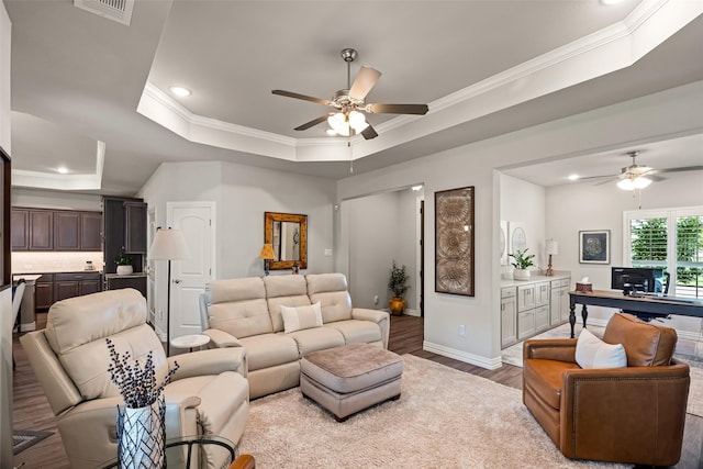 7700 Cerrito Trl, Fort Worth, TX 76123 - living room featuring a ceiling fan, a tray ceiling, wood finished floors, crown molding, and recessed lighting