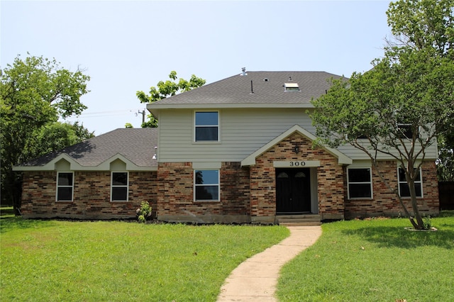 300 Woodhollow Ct, Wylie, TX 75098 - view of front of property with a front yard, a shingled roof, and brick siding