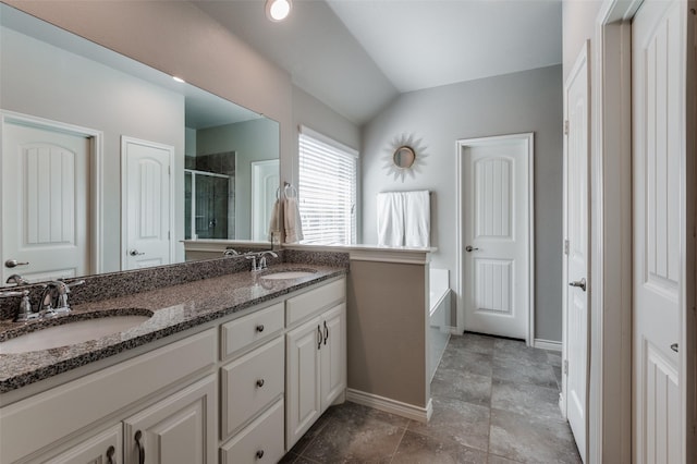2637 Hillrich Dr, Anna, TX 75409 - bathroom featuring a stall shower, double vanity, a bath, baseboards, and vaulted ceiling