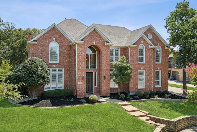 1415 Cambridge Xing, Southlake, TX 76092 - view of front of property featuring a front yard, brick siding, a chimney, and roof with shingles
