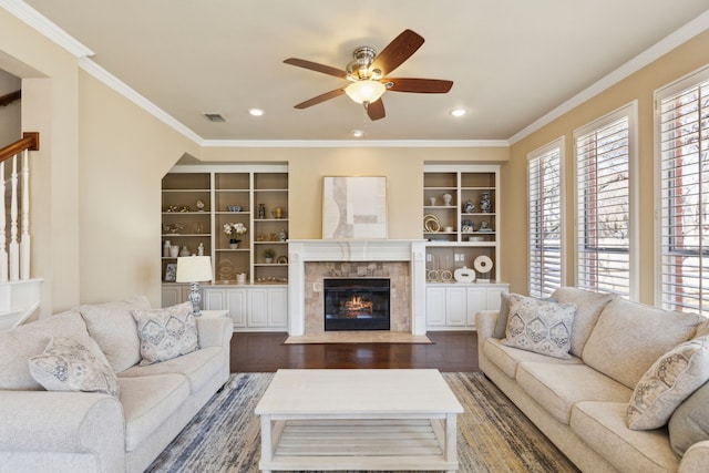 1415 Cambridge Xing, Southlake, TX 76092 - living area featuring ceiling fan, a tiled fireplace, crown molding, dark wood-type flooring, and recessed lighting