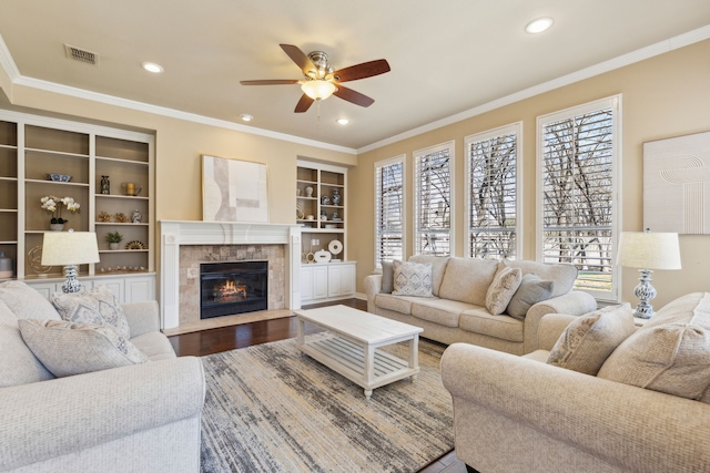 1415 Cambridge Xing, Southlake, TX 76092 - living room featuring ceiling fan, crown molding, a tiled fireplace, wood finished floors, and recessed lighting