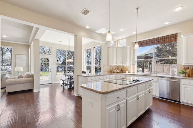 1415 Cambridge Xing, Southlake, TX 76092 - kitchen with stainless steel dishwasher, black electric cooktop, a center island, decorative backsplash, and light stone counters