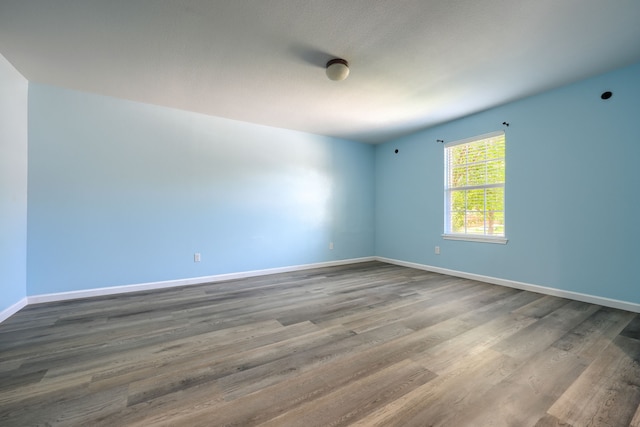 14713 Brandon Dr, Little Elm, TX 75068 - spare room featuring dark wood-type flooring and baseboards