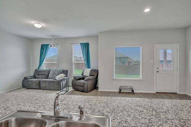 9752 New Bern Dr, Fort Worth, TX 76108 - kitchen featuring a sink, wood finished floors, recessed lighting, and baseboards