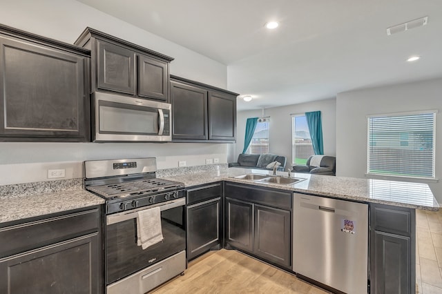 9752 New Bern Dr, Fort Worth, TX 76108 - kitchen with stainless steel appliances, a sink, a peninsula, open floor plan, and recessed lighting