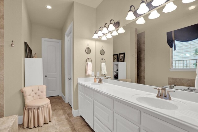 7904 Chickasaw Trl, Mckinney, TX 75070 - full bathroom with double vanity, tile patterned floors, a tub, recessed lighting, and baseboards