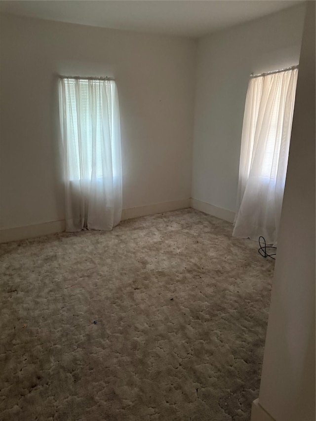 820 Goshen Rd, Springtown, TX 76082 - carpeted empty room featuring plenty of natural light and baseboards