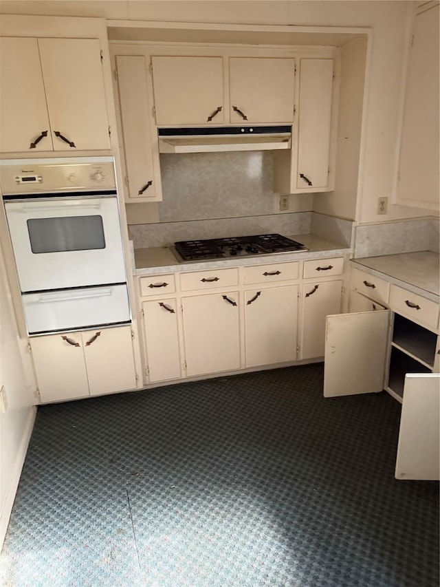 820 Goshen Rd, Springtown, TX 76082 - kitchen with oven, under cabinet range hood, stainless steel gas stovetop, a warming drawer, and light countertops