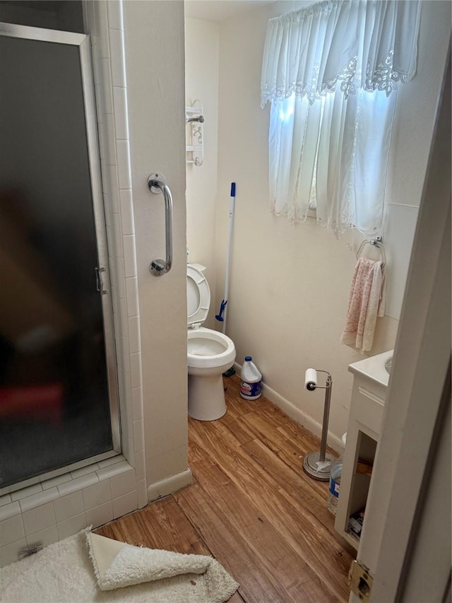 820 Goshen Rd, Springtown, TX 76082 - full bathroom featuring vanity, toilet, a stall shower, wood finished floors, and baseboards