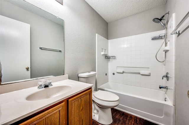 319 Quail Crossing Dr, Sanger, TX 76266 - full bathroom featuring wood finished floors, vanity, toilet, a textured ceiling, and shower / washtub combination