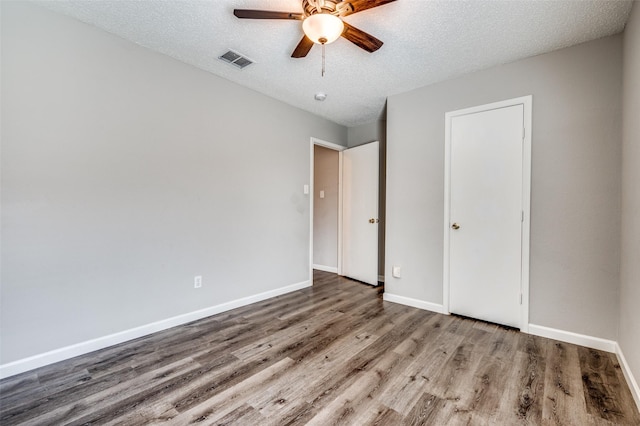 319 Quail Crossing Dr, Sanger, TX 76266 - unfurnished bedroom featuring wood finished floors, baseboards, a textured ceiling, and ceiling fan