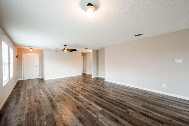319 Quail Crossing Dr, Sanger, TX 76266 - unfurnished living room featuring dark wood-type flooring, a textured ceiling, ceiling fan, and baseboards