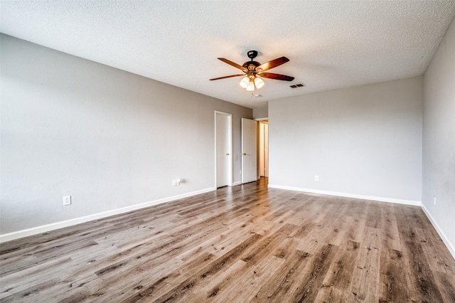 319 Quail Crossing Dr, Sanger, TX 76266 - spare room featuring wood finished floors, ceiling fan, baseboards, and a textured ceiling