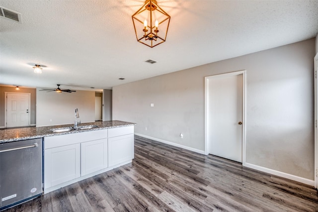 319 Quail Crossing Dr, Sanger, TX 76266 - kitchen featuring stainless steel dishwasher, a sink, wood finished floors, and stone counters