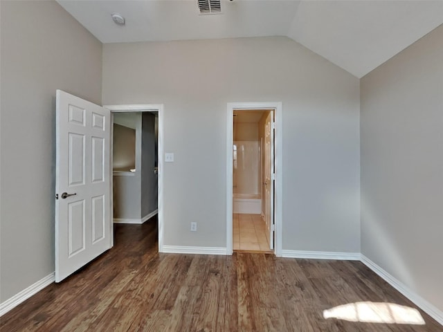 1104 Cactus Spine Dr, Fort Worth, TX 76052 - unfurnished bedroom with wood finished floors, lofted ceiling, baseboards, and connected bathroom