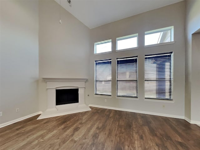 1104 Cactus Spine Dr, Fort Worth, TX 76052 - unfurnished living room featuring high vaulted ceiling, plenty of natural light, a fireplace with raised hearth, and wood finished floors