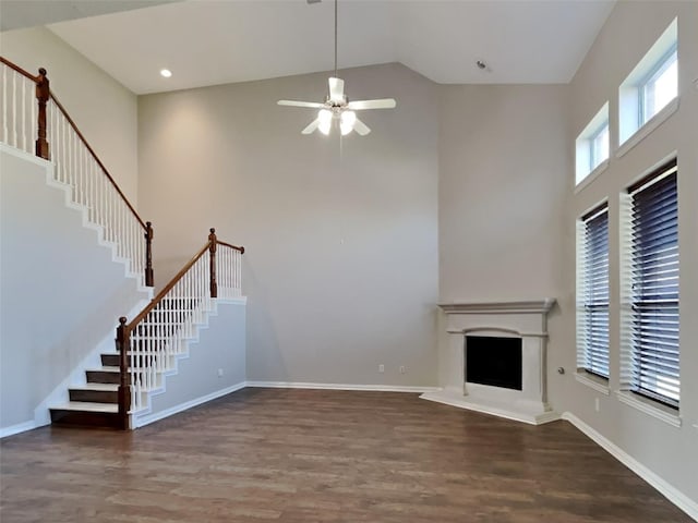 1104 Cactus Spine Dr, Fort Worth, TX 76052 - unfurnished living room with high vaulted ceiling, wood finished floors, stairs, ceiling fan, and a fireplace with raised hearth