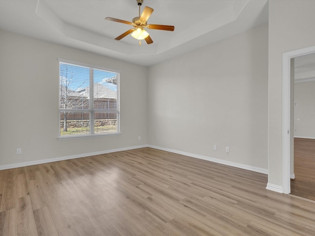 125 Gill Point Ln, Aledo, TX 76008 - empty room featuring a tray ceiling, light wood-style floors, ceiling fan, and baseboards