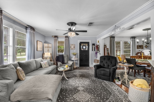 6440 Harmonson Rd, North Richland Hills, TX 76180 - living room with a ceiling fan, ornamental molding, wood finished floors, and a chandelier